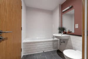 Bathroom with bathtub and sink in Highland Club Scotland property.