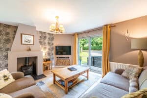 Bright Highland Club living room with fireplace, large window, and comfortable sofas.