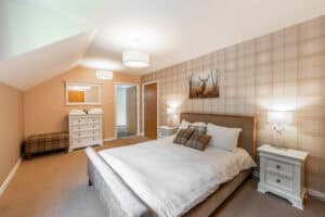 Highland Club Scotland bedroom with elegant decor and scenic views of the surrounding landscape.