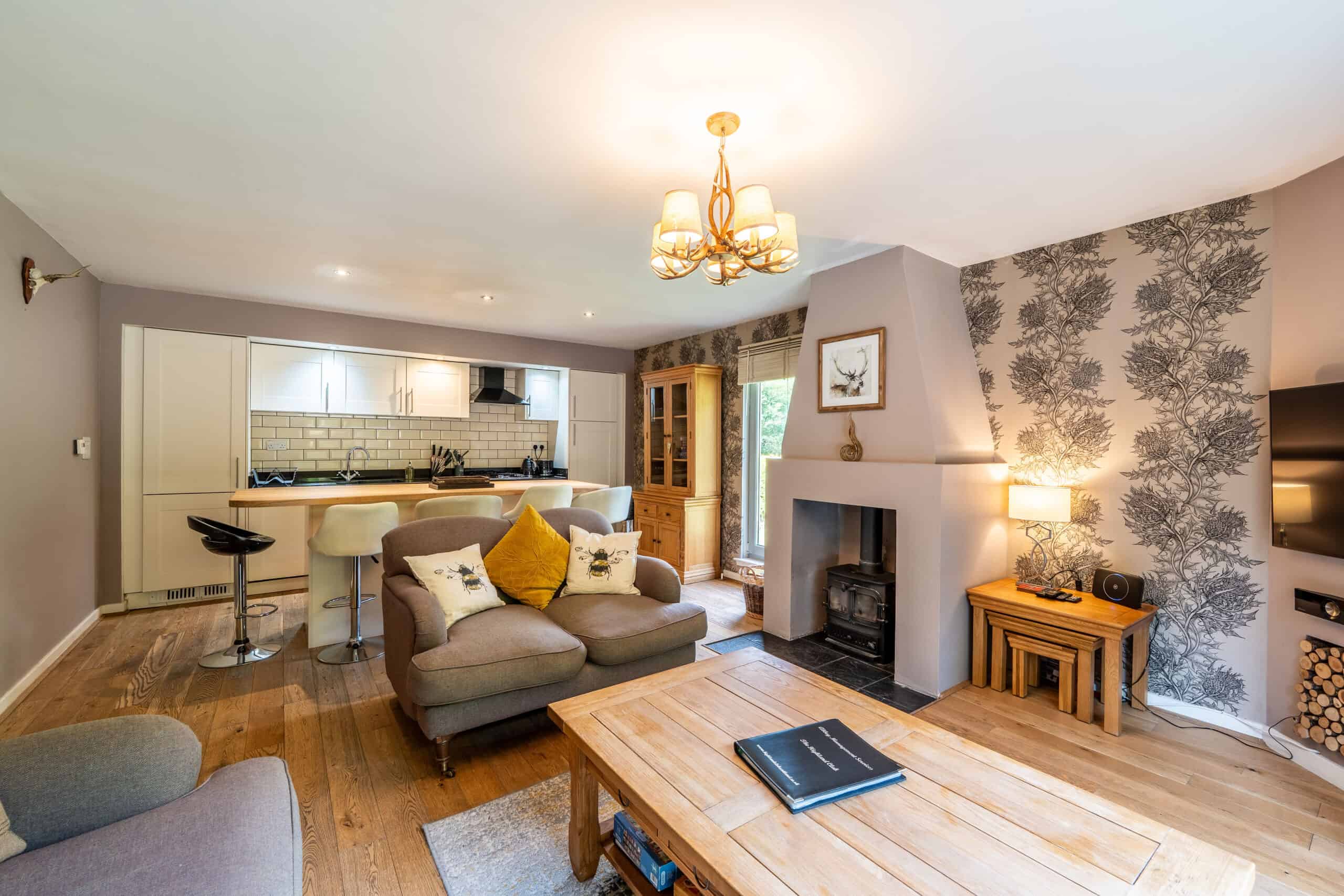 Spacious Highland living room with modern decor and cozy fireplace.
