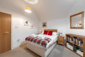 Bedroom at Highland Club Scotland with cosy decor and modern furnishings.