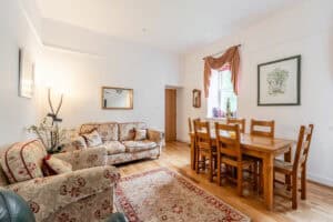 Bright and inviting Highland Club living room with traditional furnishings and natural light.