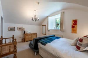 Comfortable Highland Club bedroom with a cozy bed and natural light.