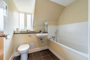 Bathroom with bathtub, toilet, and sink in Highland Club Scotland development.