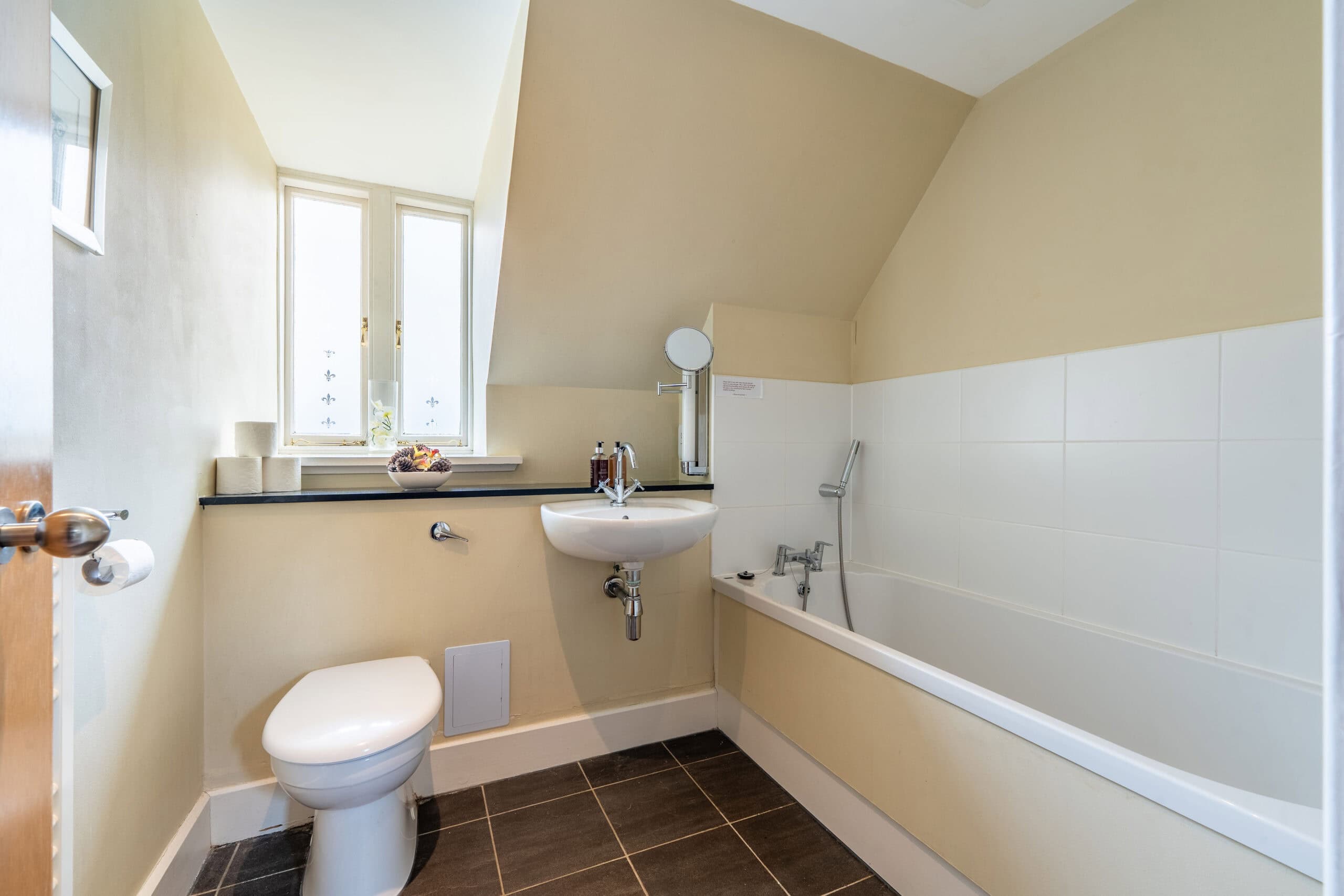 Bathroom with bathtub and toilet in Highland Club Scotland development.