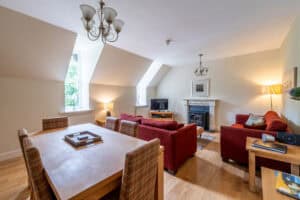 Bright Highland Club lounge with comfortable seating and fireplace.
