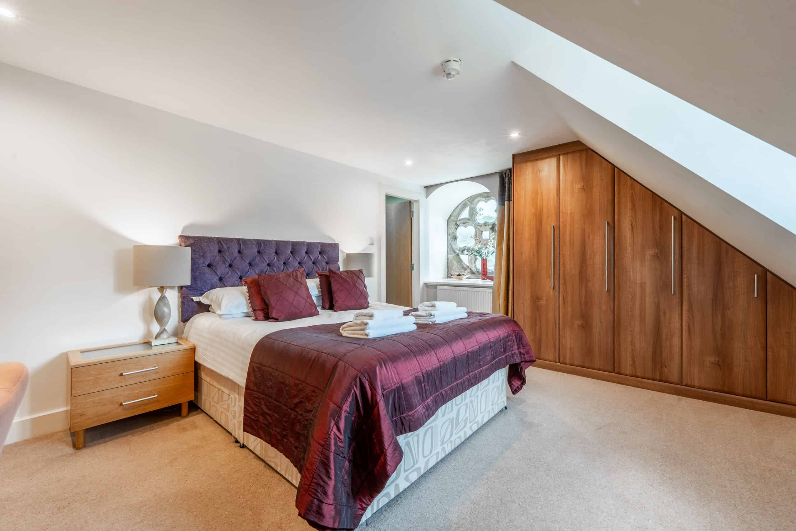 Luxury Highland Club bedroom with modern furnishings and scenic window views.