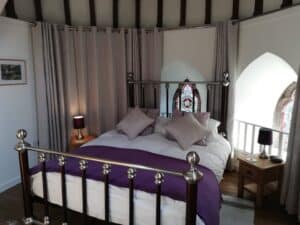 Elegant bedroom at Highland Club Scotland with vintage decor and scenic views.