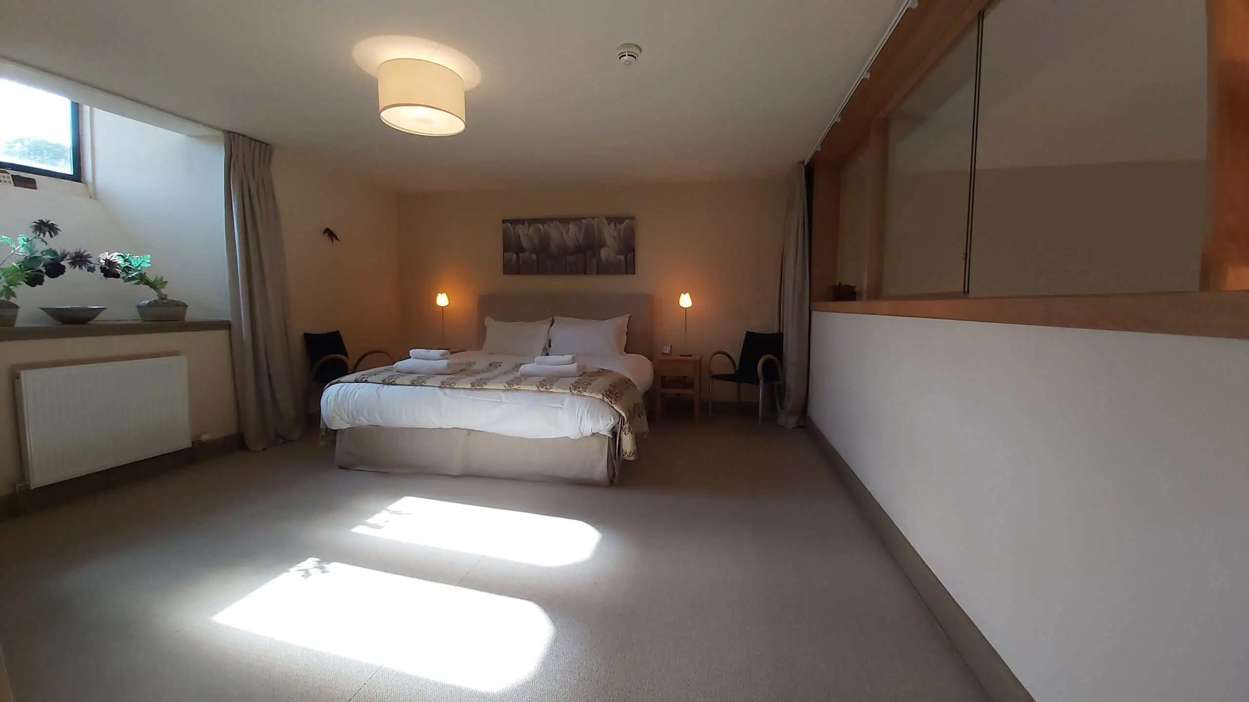 Luxury Highland Club bedroom with natural light and modern decor.