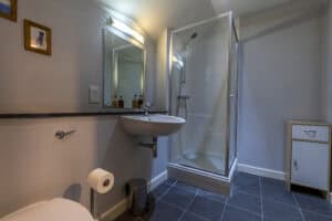 Modern bathroom with shower enclosure, sink, and toilet at Highland Club Scotland.