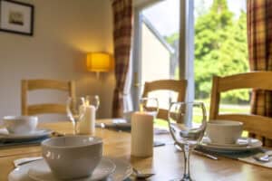 Modern dining room with large window and natural light in Highland Club Scotland.