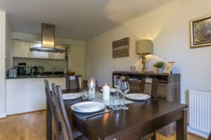 Modern dining area with elegant table setting in Highland Club Scotland development.