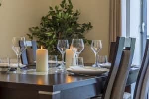 Elegant dining room setup with candles and glassware at Highland Club Scotland development.