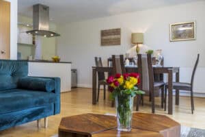 Modern Highland Club Scotland apartment interior with dining area and floral decor.