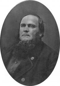 A black and white historical portrait of a stern-looking man with a beard and Civil War-era clothing.