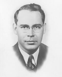 Dempseyjpg Black and white portrait of a young man in vintage attire, representing historical figures.