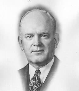 JessePavey Black and white portrait of a distinguished man in formal suit, showcasing historical attire and prominence.