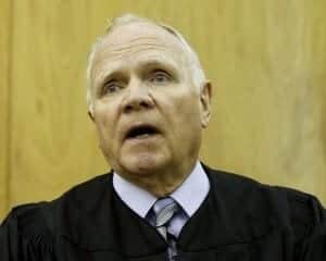 Nemeth Aging judge speaking in courtroom, judicial robes, legal proceedings, courtroom setting, legal system, courtroom judge, law, justice.