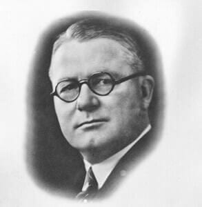 WmHinkle Vintage black and white portrait of a man wearing glasses.