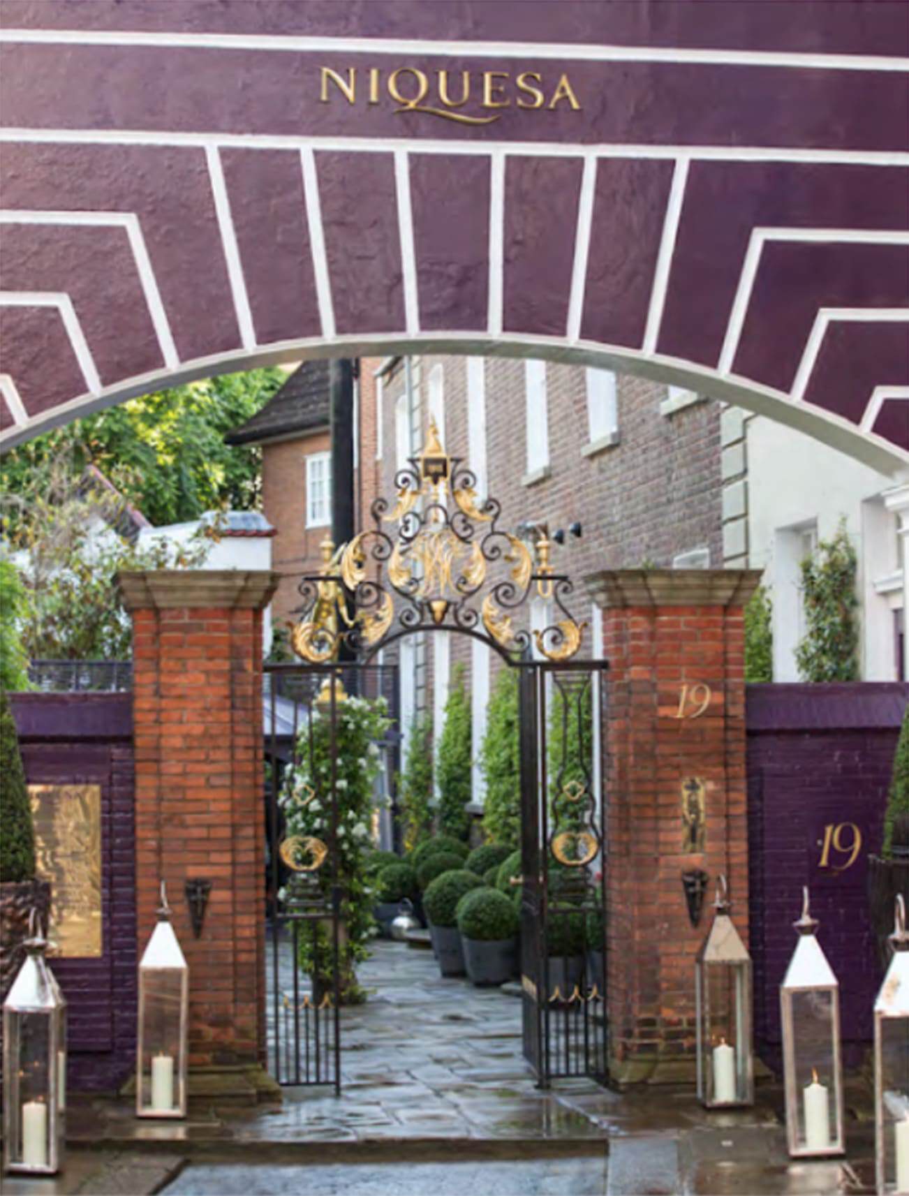 Elegant wrought iron gate with brick pillars at Niquesa in Belgravia, London.
