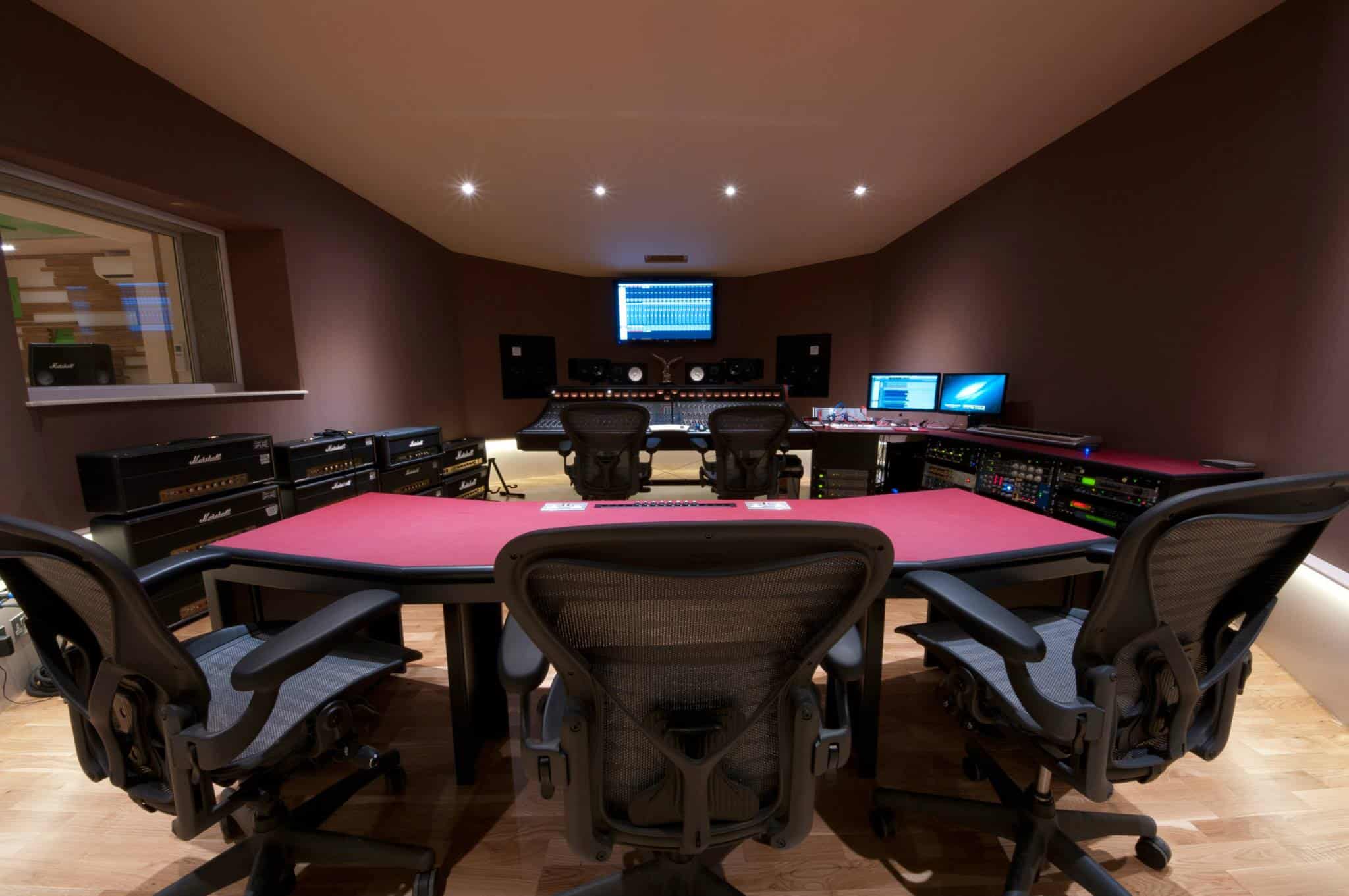 Professional recording studio with mixing console and audio equipment for music production.