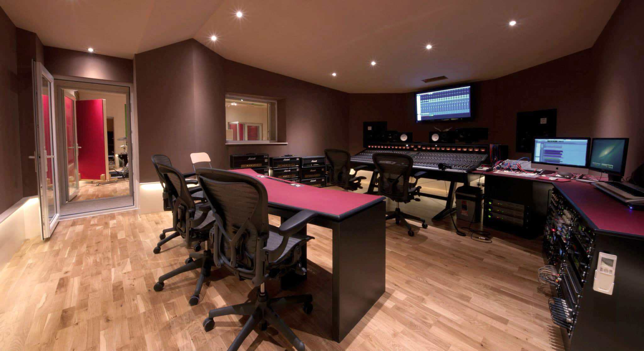 Professional recording studio with mixing consoles and sound equipment.