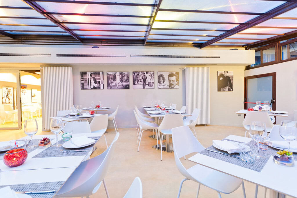 Elegant restaurant interior with modern decor and table settings in Milan.