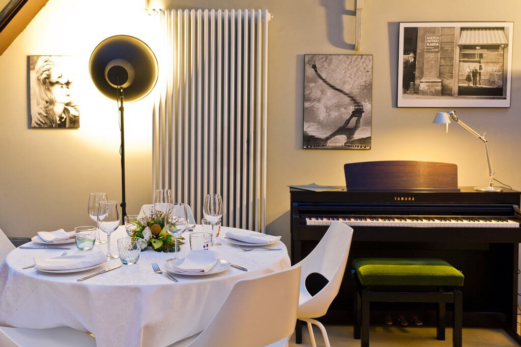 Elegant restaurant interior with a piano and art decor in Milan.