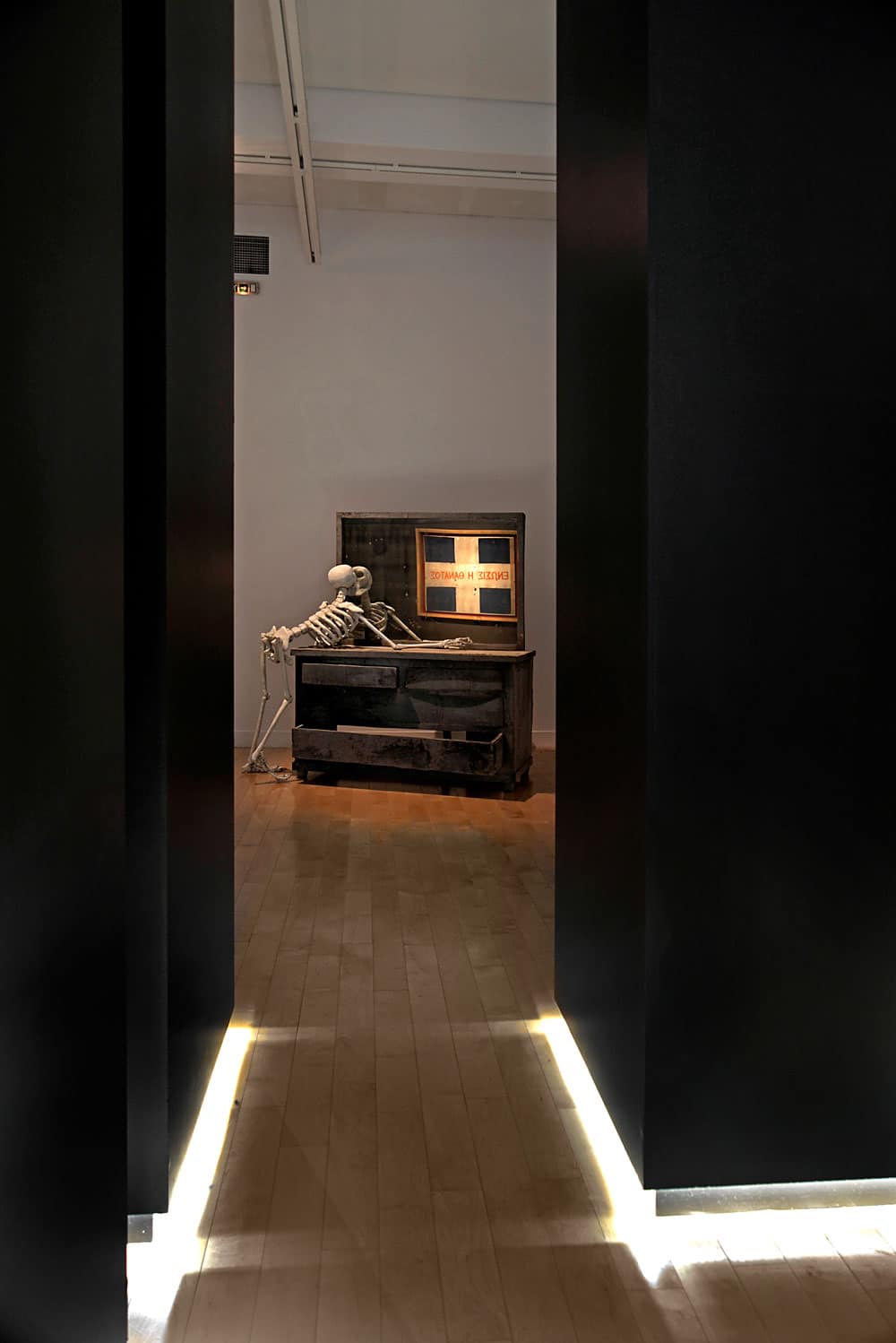 Modern interior with vintage TV and skeleton decor in a minimalist setting.
