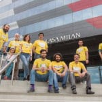 Group Of People Wearing Hit Architects T-Shirts Outside Casa Milan Building.