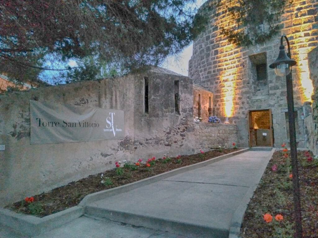 Exterior view of Torre San Vittorio museum in Carloforte at dusk.