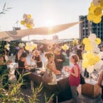 Outdoor Media Event With Balloons And People During Sunset In An Urban Setting.