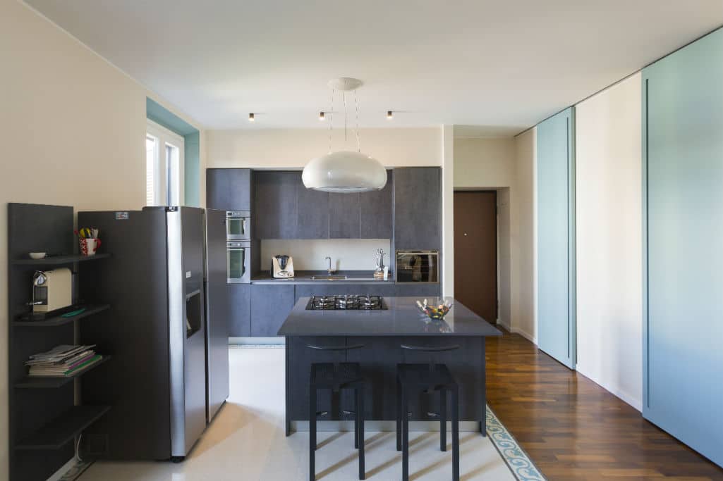 Modern kitchen with sleek dark cabinetry and minimalist design.
