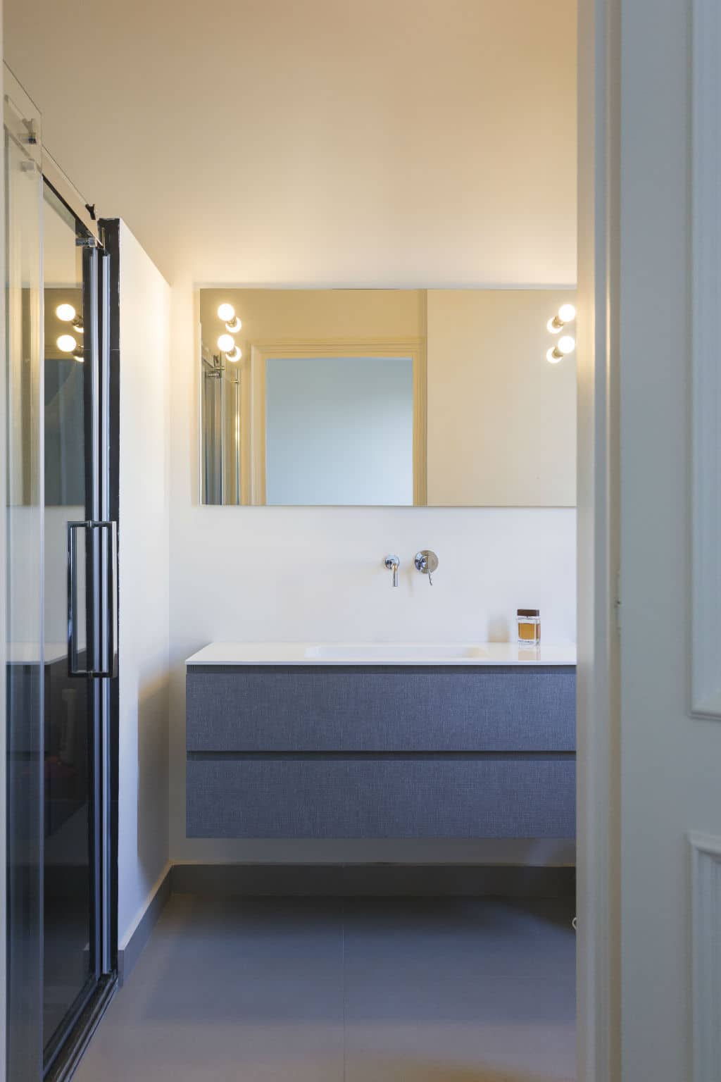 Modern bathroom with minimalist design and sleek vanity unit.