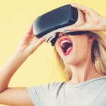 Young Woman Using Virtual Reality Headset With Excitement.