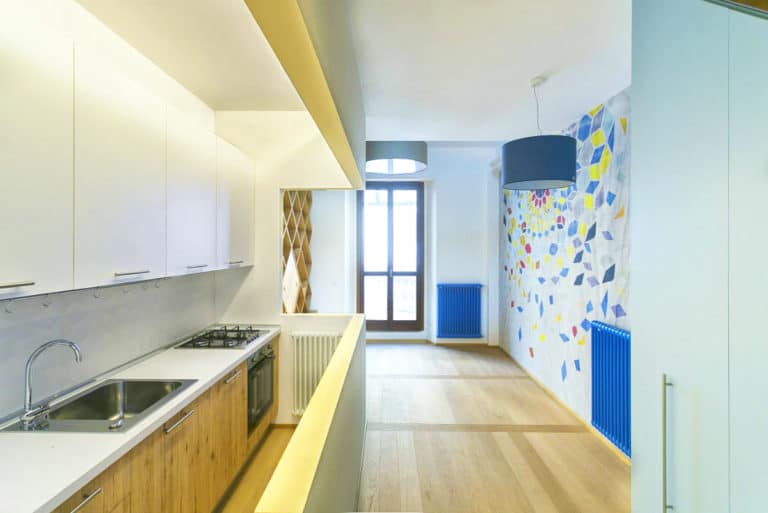 Modern Kitchen With Colorful Wall Art And Bright Natural Light.