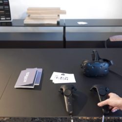 Virtual Reality Headset And Controllers On A Black Table At Salone Del Mobile 2017.