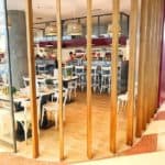Contemporary Food Court With Wooden Dividers And Stylish Lighting.