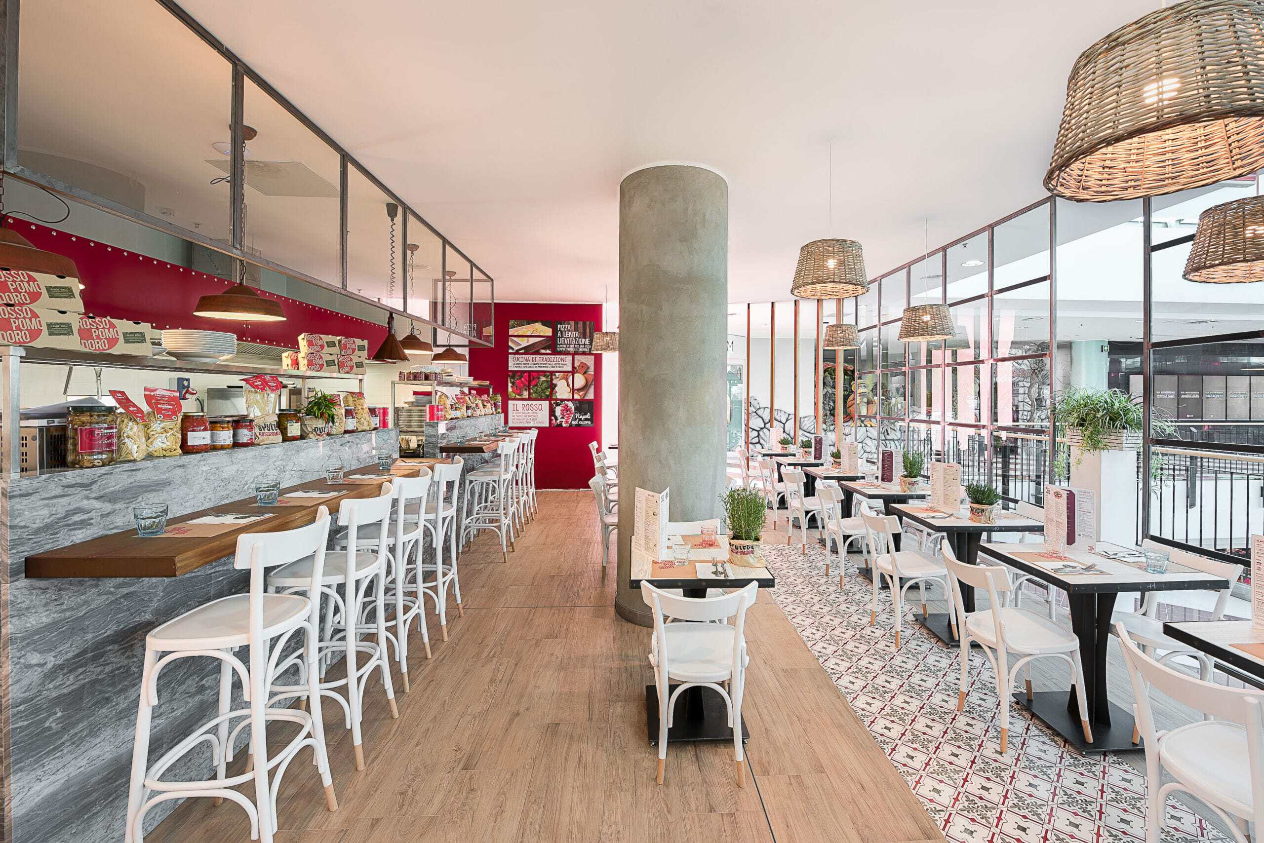 Modern restaurant interior with bar and dining area at Rossopomodoro.