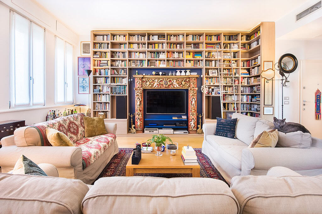 Elegant living room with large built-in bookshelf and cozy seating area.