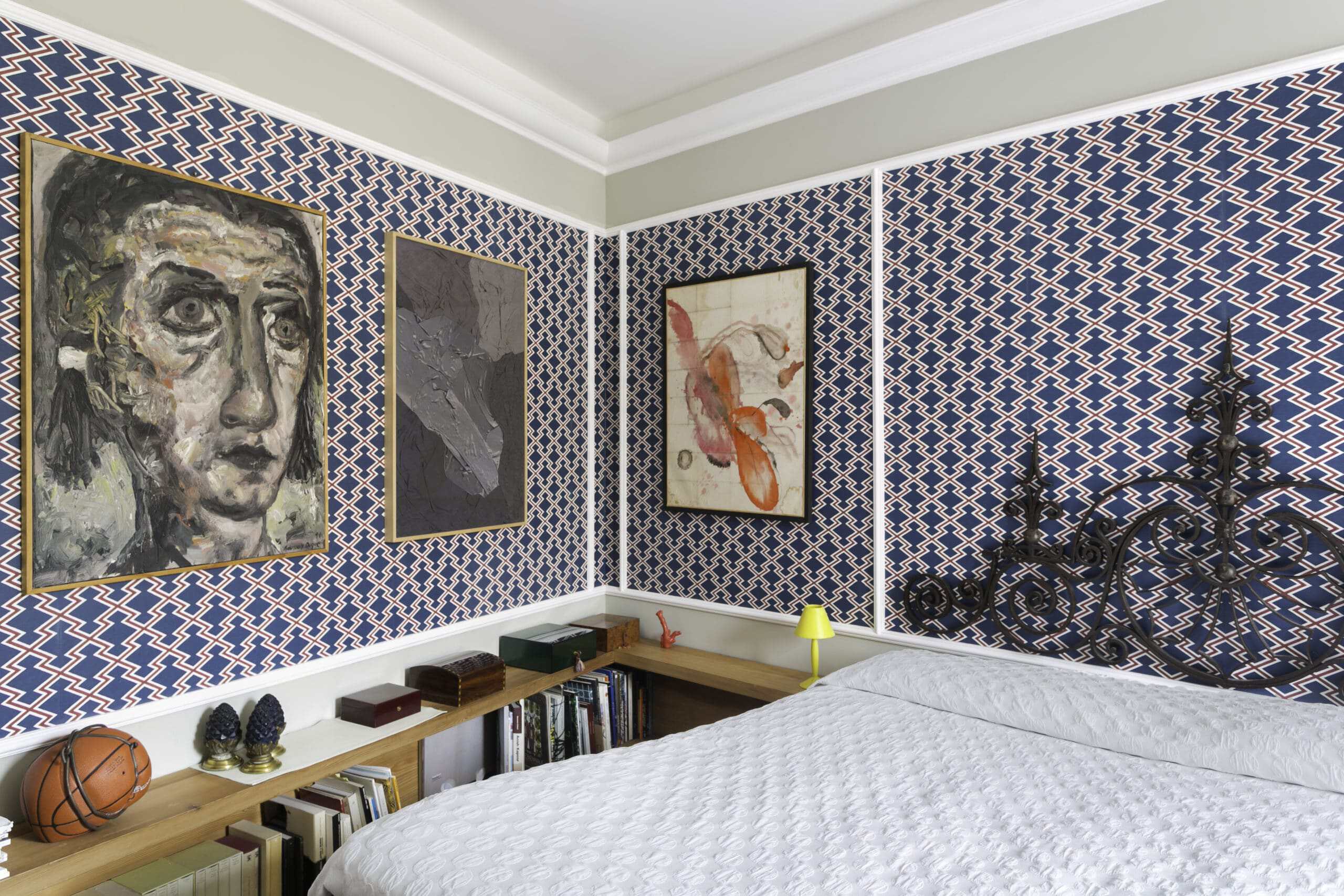 Interior of a collector's house with artwork and patterned wallpaper.