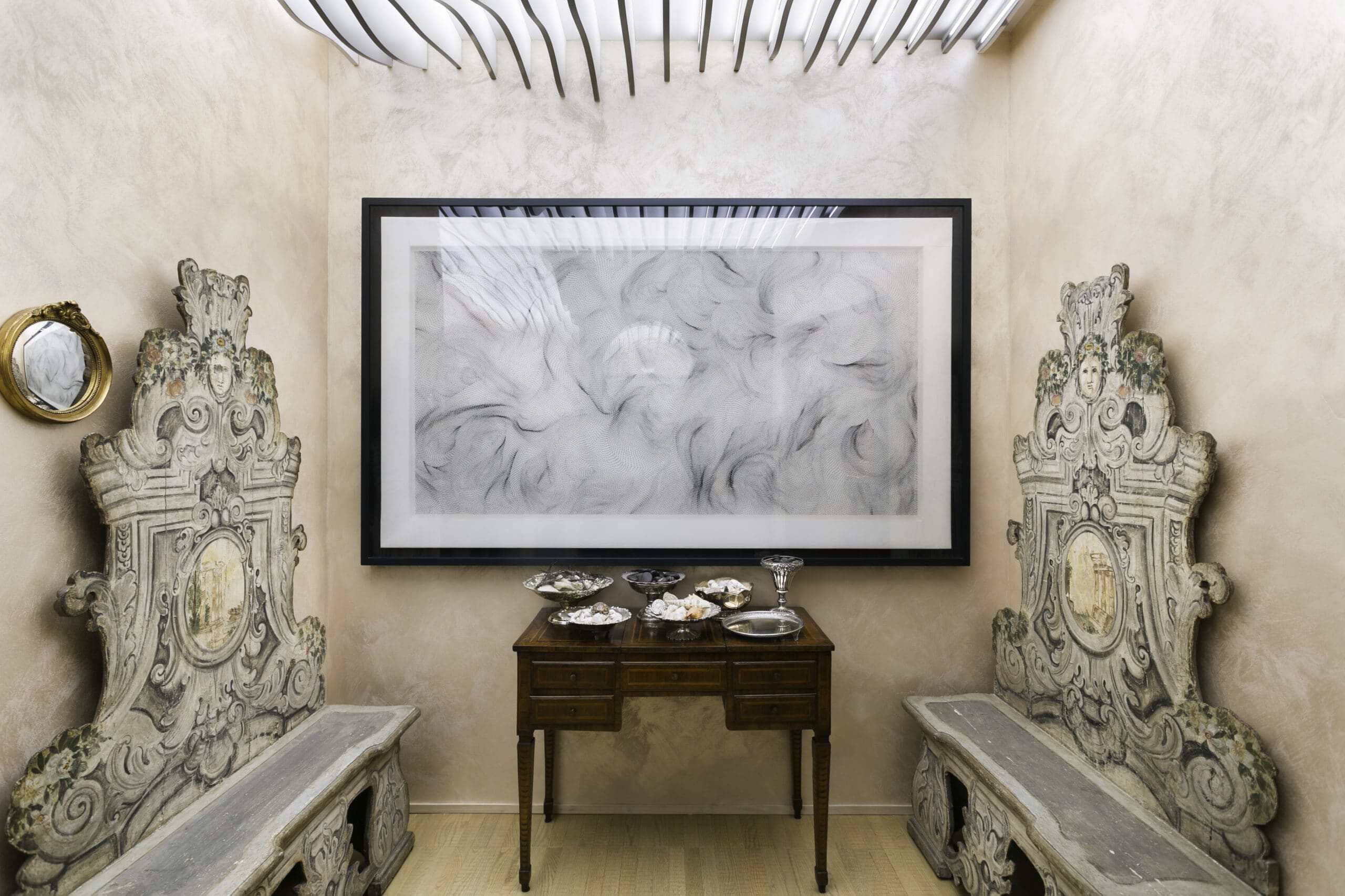 Elegant antique chairs and artwork in a stylish interior setting.