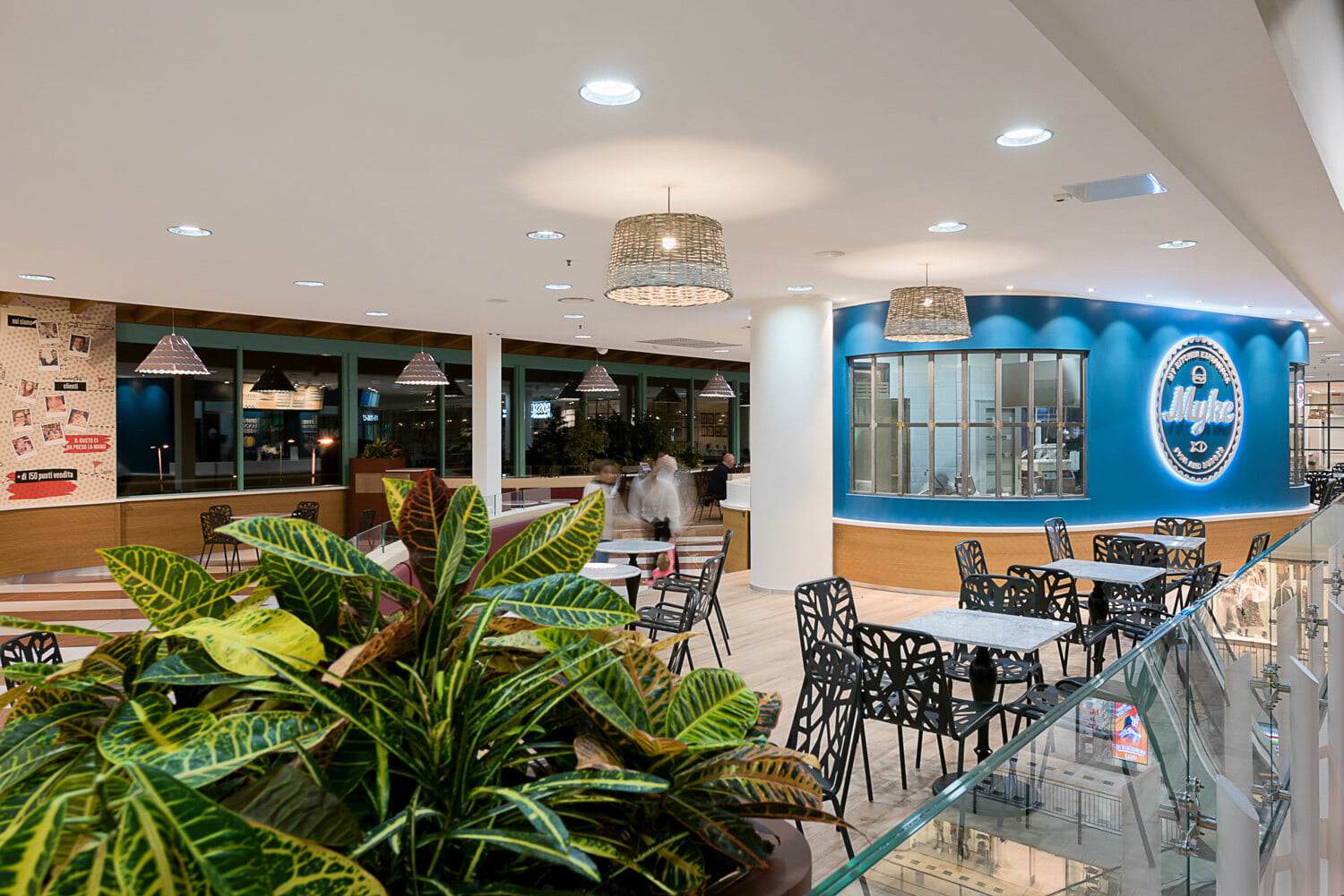 Interior view of Myke Fish & Burger restaurant with modern decor and seating area.