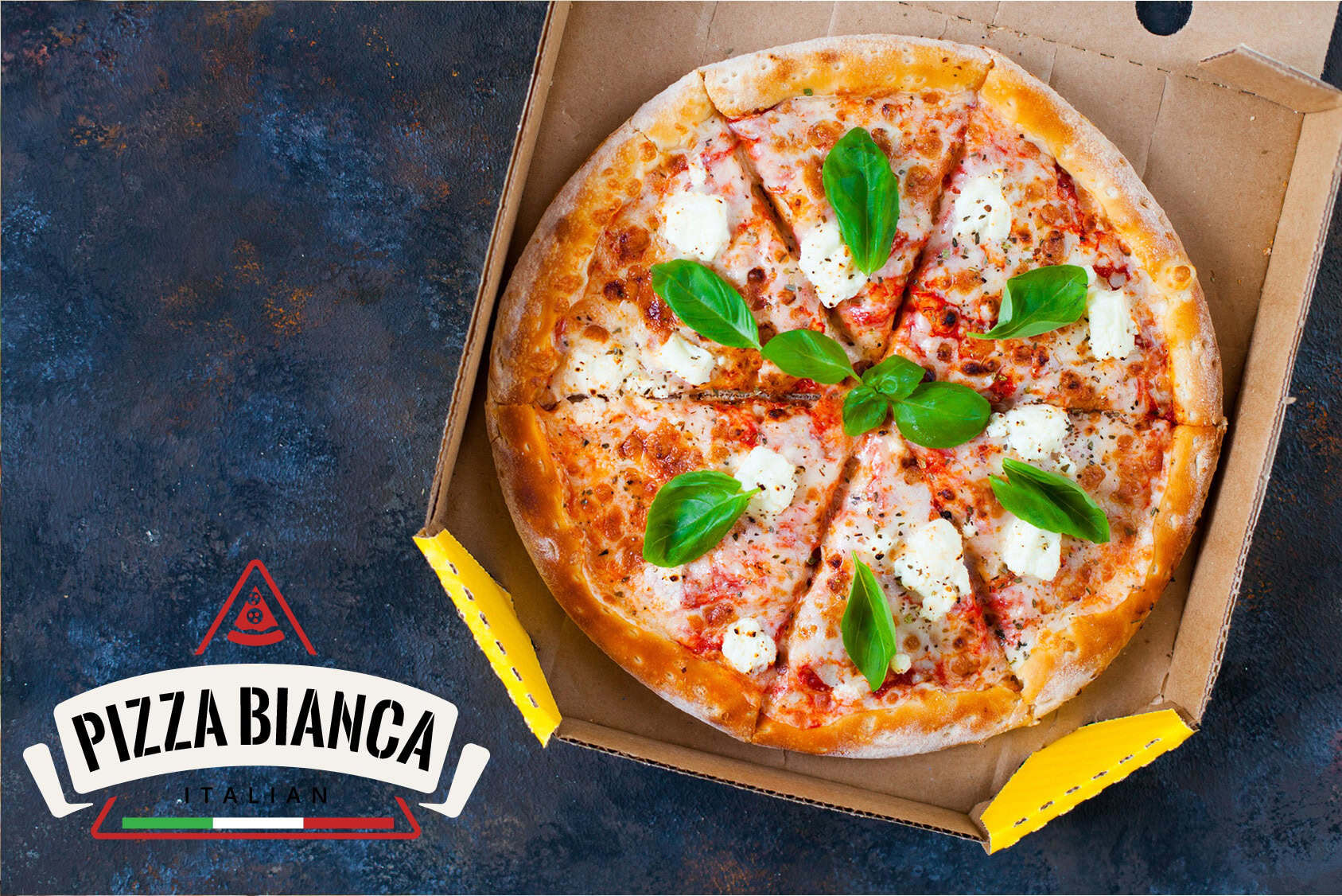 Fresh Pizza Bianca with basil leaves in a pizza box on a dark surface.