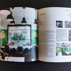 Modern Interior Design Office With Green Accents And Black Pendant Lights.