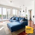 Modern Living Room With Large Windows And Blue Sofa, Bright And Airy Space.