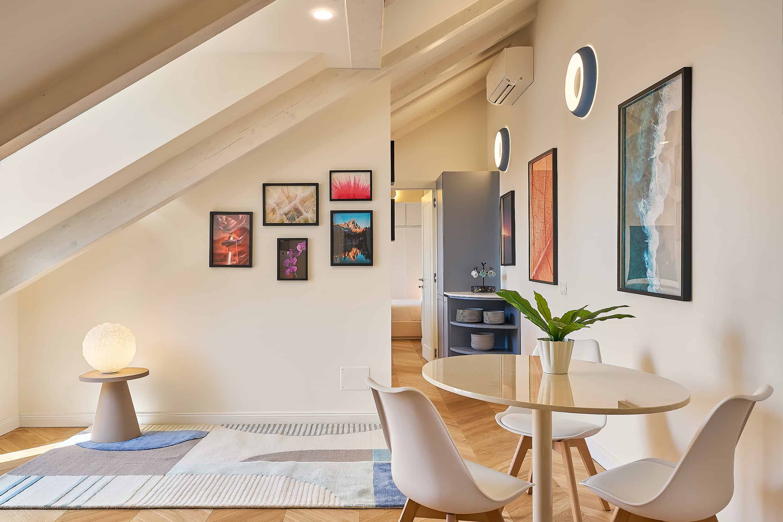 Bright Attic Apartment With Minimalist Decor And Artwork.