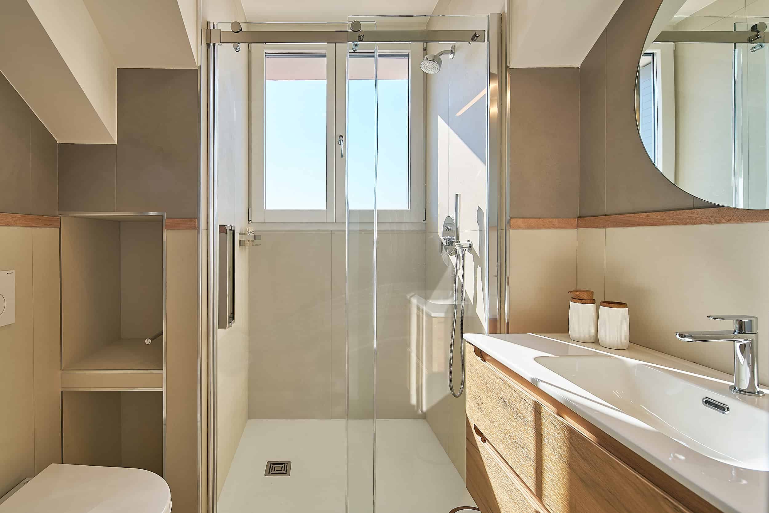 Contemporary bathroom with walk-in shower and wooden vanity.