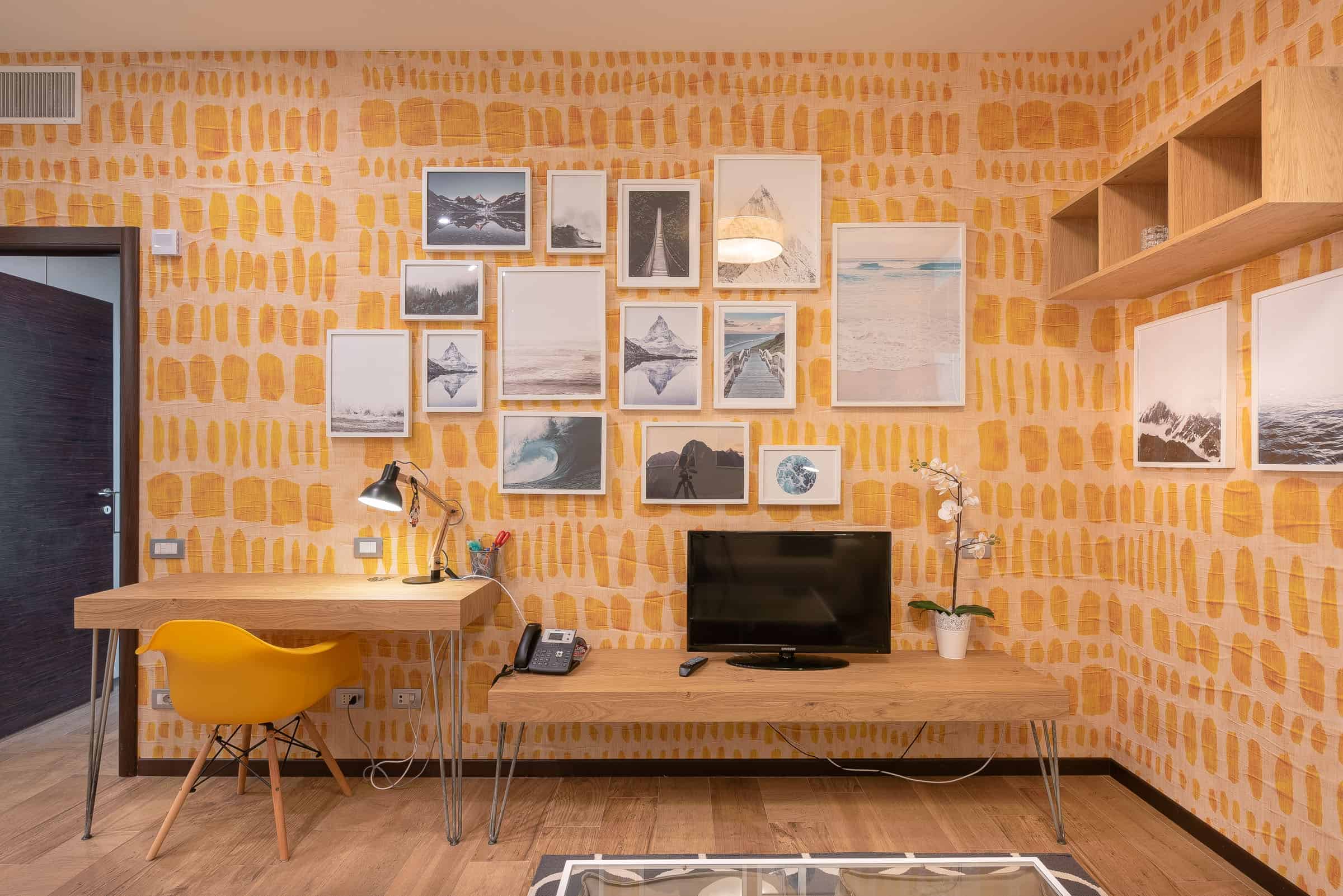 Contemporary living room with a gallery wall of framed artwork and wooden furniture.