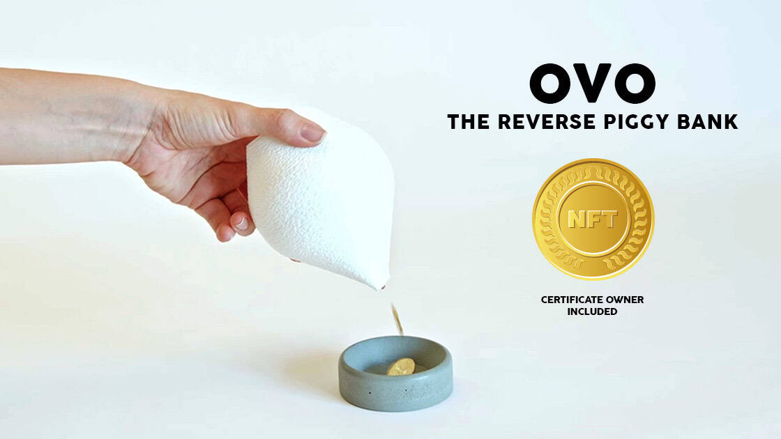 Hand Holding A White Foam Object Over A Small Dish With A Coin, Promoting Ovo Nft Project.